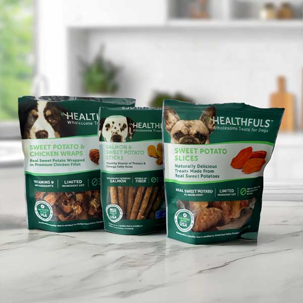 Three Healthfuls Bags of treats – Sweet Potato and Chicken Wraps, Salmon and Sweet Potato Sticks and Sweet Potato Slices on a white marble Kitchen Counter